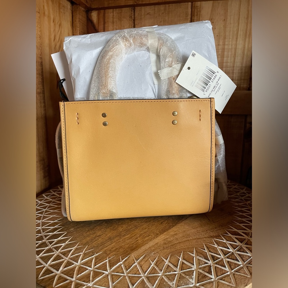 SOLD elsewhere. NWT Coach Rogue 17. Color is “Carrot” and the bag is YELLOW